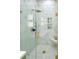 Elegant bathroom with glass shower, gold hardware and marble walls and floors at 3180 Lee Dr, Buford, GA 30518