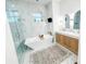 Modern bathroom featuring marble-style tile, soaking tub, and double sink vanity at 3180 Lee Dr, Buford, GA 30518
