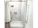 Clean bathroom featuring a marble tiled tub and shower combo with gold fixtures at 3180 Lee Dr, Buford, GA 30518