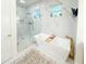 Stunning bathroom with a soaking tub, marble accents, and a glass-enclosed shower at 3180 Lee Dr, Buford, GA 30518