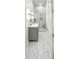 Stylish bathroom showcasing a glass shower, marble floors, and a modern green vanity at 3180 Lee Dr, Buford, GA 30518