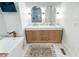 Elegant bathroom features a large soaking tub, dual vanities and marble styled tile at 3180 Lee Dr, Buford, GA 30518