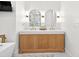 Stylish bathroom vanity with dual sinks, modern lighting, and elegant countertops at 3180 Lee Dr, Buford, GA 30518