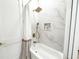 Bathroom featuring a marble tiled tub and shower combo with a gold rainfall shower head at 3180 Lee Dr, Buford, GA 30518