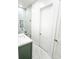 Well lit bathroom with marble tile shower and vanity with green cabinets at 3180 Lee Dr, Buford, GA 30518