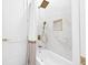 Bathroom featuring a modern shower and tub combo with gold fixtures and a recessed shower niche at 3180 Lee Dr, Buford, GA 30518