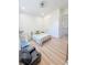Well-lit bedroom featuring light-colored wood flooring and a window with outdoor views at 3180 Lee Dr, Buford, GA 30518