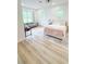 Bright bedroom featuring plush bedding, a comfortable seating area, and hardwood floors at 3180 Lee Dr, Buford, GA 30518