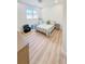 Bright bedroom with light-colored wood floors and a window with views of the backyard at 3180 Lee Dr, Buford, GA 30518
