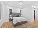 Bright bedroom featuring a tufted headboard, natural light, and a stylish decorative rug on wood floors at 3180 Lee Dr, Buford, GA 30518