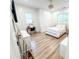 Bright bedroom featuring wood floors, a white-framed bed, a mirrored dresser, and a desk near a window at 3180 Lee Dr, Buford, GA 30518