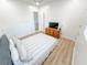 Bright bedroom features a comfortable queen bed, wood floors, dresser and modern fixtures at 3180 Lee Dr, Buford, GA 30518