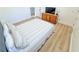 Bright and airy bedroom with hardwood floors, a comfortable bed and dresser with mounted TV at 3180 Lee Dr, Buford, GA 30518
