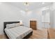 Bright bedroom features wood floors, white walls, and a bed with decorative pillows and duvet cover at 3180 Lee Dr, Buford, GA 30518