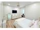 This bedroom features an accent mirror, light wood floors, and a modern ceiling fan at 3180 Lee Dr, Buford, GA 30518