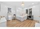 Cozy bedroom with a decorative light fixture, dresser, and large windows at 3180 Lee Dr, Buford, GA 30518