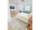 Spacious bedroom with large rug, a dresser, a vanity, seating, and hardwood flooring at 3180 Lee Dr, Buford, GA 30518