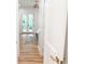 Hallway view of the primary bedroom with hardwood flooring and double doors to a private deck at 3180 Lee Dr, Buford, GA 30518