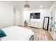 A calming bedroom boasts a large TV, sleek dresser, and access to outdoor balcony at 3180 Lee Dr, Buford, GA 30518