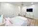 A contemporary bedroom showcases a mounted TV, with light wood flooring and modern decor at 3180 Lee Dr, Buford, GA 30518