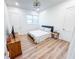 Bedroom features wood-look floors, a wooden dresser, a bed with a gray headboard, and white trim at 3180 Lee Dr, Buford, GA 30518