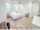 Bright bedroom with light wood flooring, ceiling fan, and natural light at 3180 Lee Dr, Buford, GA 30518