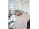 Bright bedroom featuring a comfortable couch, workout equipment, and hardwood flooring at 3180 Lee Dr, Buford, GA 30518