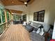 Relax on this home's covered deck with ceiling fans overlooking a private backyard at 3180 Lee Dr, Buford, GA 30518