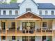 Close-up of a spacious deck with outdoor seating and sliding glass doors leading into the home at 3180 Lee Dr, Buford, GA 30518