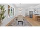Elegant dining room featuring a modern chandelier, large windows, and an open view of the kitchen at 3180 Lee Dr, Buford, GA 30518
