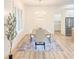 Elegant dining room with a chandelier, light wood floors, and kitchen access at 3180 Lee Dr, Buford, GA 30518