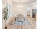 Bright dining area featuring modern chandelier, large windows, and neutral décor at 3180 Lee Dr, Buford, GA 30518
