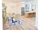 Elegant dining room with a chandelier, light wood floors, and kitchen access at 3180 Lee Dr, Buford, GA 30518