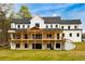 Rear view of home features a spacious wooden deck perfect for outdoor entertaining at 3180 Lee Dr, Buford, GA 30518