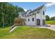 Two-story home featuring a covered patio, black-framed windows, and a three-car garage at 3180 Lee Dr, Buford, GA 30518