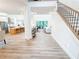 Bright foyer with light wood floors leading to an open-concept living area at 3180 Lee Dr, Buford, GA 30518