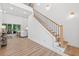 Light-filled foyer with hardwood floors, a staircase, and a glimpse of the living area at 3180 Lee Dr, Buford, GA 30518