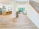 Bright and airy foyer featuring light wood floors, a staircase, and an open view to the living spaces at 3180 Lee Dr, Buford, GA 30518