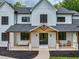 Inviting front porch with wood beams, comfortable seating, and stylish lighting, enhancing curb appeal at 3180 Lee Dr, Buford, GA 30518