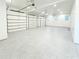 Spacious garage with epoxy floors, overhead lighting, and three roll up doors at 3180 Lee Dr, Buford, GA 30518