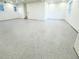 Finished garage with light gray epoxy flooring and two windows at 3180 Lee Dr, Buford, GA 30518