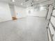 Spacious three car garage featuring epoxy flooring, recessed lighting, and access door at 3180 Lee Dr, Buford, GA 30518