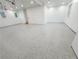 Large and open garage with epoxy flooring, ample lighting, and plenty of space at 3180 Lee Dr, Buford, GA 30518