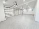 Spacious three-car garage with epoxy flooring, multiple garage doors, and ample lighting at 3180 Lee Dr, Buford, GA 30518