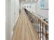 Hallway overlooks the living room with hardwood floors and black metal railings at 3180 Lee Dr, Buford, GA 30518
