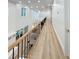 Spacious second story hallway featuring hardwood floors and views to downstairs living areas at 3180 Lee Dr, Buford, GA 30518