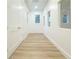 Bright hallway with neutral walls, white doors, and hardwood flooring at 3180 Lee Dr, Buford, GA 30518