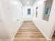 Long hallway featuring wood floors, white walls, doors, and natural lighting from windows at 3180 Lee Dr, Buford, GA 30518