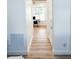 Hallway with stylish wood flooring connects to an office space at 3180 Lee Dr, Buford, GA 30518