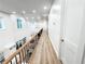 Bright hallway featuring wood floors, wood railing, and recessed lighting at 3180 Lee Dr, Buford, GA 30518